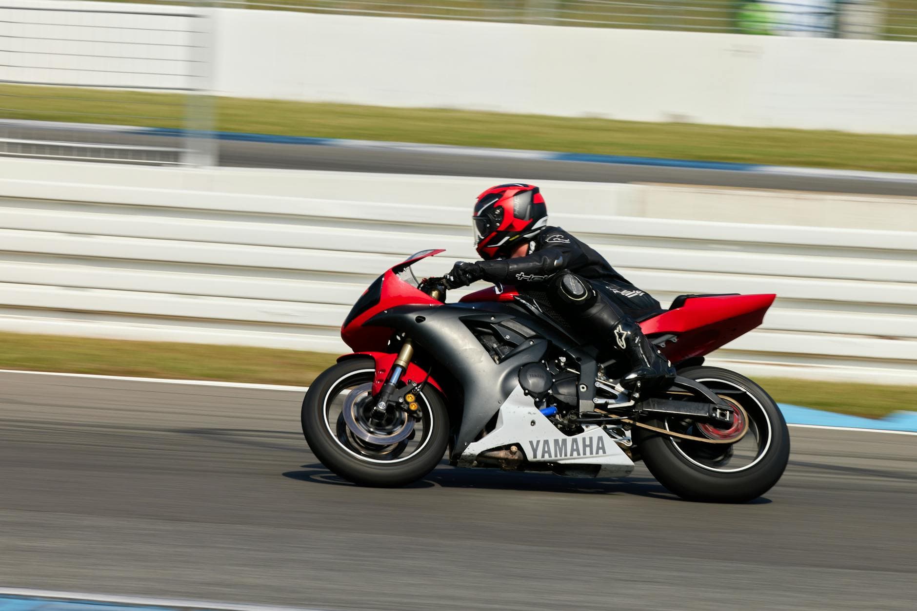 A motorcyclist in full gear speedily navigates the Hockenheim race track in Germany on a Yamaha bike.