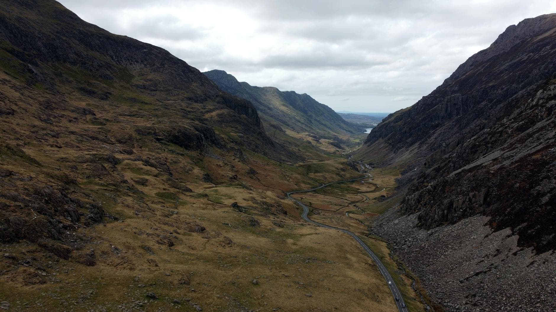 Scenic aerial view of an expansive Welsh valley with winding roads.